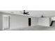 Open living space with neutral walls, ceiling fans and multiple doors at 5925 Seaside Dr, New Port Richey, FL 34652
