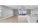 Spacious living room featuring hardwood floors, sliding doors to patio, and high ceilings at 5925 Seaside Dr, New Port Richey, FL 34652