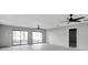 Large living room with ceiling fans and sliding glass doors leading to a patio at 5925 Seaside Dr, New Port Richey, FL 34652
