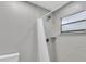 Clean shower with grey tile and white curtain at 5925 Seaside Dr, New Port Richey, FL 34652
