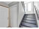 Modern staircase with gray painted steps and white doors at 5925 Seaside Dr, New Port Richey, FL 34652