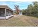 View of backyard with shed and screened porch at 6166 Newmark St, Spring Hill, FL 34606