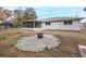Fire pit area with rock border in backyard at 6166 Newmark St, Spring Hill, FL 34606