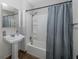 Updated bathroom with tub shower, and pedestal sink at 6166 Newmark St, Spring Hill, FL 34606