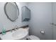 Clean and updated bathroom with pedestal sink and tiled floor at 6166 Newmark St, Spring Hill, FL 34606