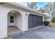 Two-car garage with dark gray doors and tiled entryway at 6166 Newmark St, Spring Hill, FL 34606