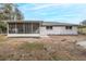 Back of house with screened porch and yard at 6166 Newmark St, Spring Hill, FL 34606