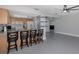 Kitchen with oak cabinets, breakfast bar, and black stools at 6166 Newmark St, Spring Hill, FL 34606