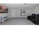 Living room with gray flooring and black reclining chairs at 6166 Newmark St, Spring Hill, FL 34606