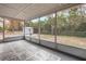 Screened porch overlooking backyard and wooded area at 6166 Newmark St, Spring Hill, FL 34606