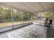 Screened porch with a grill and view of the backyard at 6166 Newmark St, Spring Hill, FL 34606