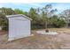 White storage shed in the backyard at 6166 Newmark St, Spring Hill, FL 34606