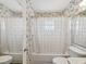 Bathroom with floral wallpaper and a shower/tub combo at 7037 Versailles N # 15, Pinellas Park, FL 33781