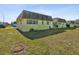 Yellow house exterior with a small deck and lawn at 7037 Versailles N # 15, Pinellas Park, FL 33781