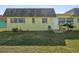 Yellow exterior of home with small lawn at 7037 Versailles N # 15, Pinellas Park, FL 33781