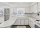 White kitchen with ample cabinetry and a peninsula countertop at 7037 Versailles N # 15, Pinellas Park, FL 33781