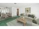 Living room with beige couch, coffee table, and dining area at 7037 Versailles N # 15, Pinellas Park, FL 33781