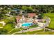Community clubhouse with pool and surrounding landscape at 7267 Prince George Ct, Spring Hill, FL 34606