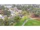 Aerial view of community featuring townhouses near a golf course and lake at 7267 Prince George Ct, Spring Hill, FL 34606