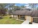 Tan single story home with a two car garage and green lawn at 7267 Prince George Ct, Spring Hill, FL 34606