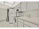 Bright kitchen featuring white cabinets and appliances at 7267 Prince George Ct, Spring Hill, FL 34606