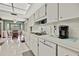 Open kitchen with white cabinets, and view into dining area at 7267 Prince George Ct, Spring Hill, FL 34606
