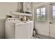 Convenient laundry room with washer, dryer, and exterior access at 7267 Prince George Ct, Spring Hill, FL 34606