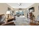 Spacious living area featuring a view into sunroom and wood floors at 7267 Prince George Ct, Spring Hill, FL 34606