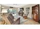 Living room with wood-look floors, rocking chair, and built-in shelving at 7267 Prince George Ct, Spring Hill, FL 34606