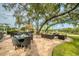 Outdoor patio furniture under a large tree at 7267 Prince George Ct, Spring Hill, FL 34606