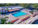 Community pool with surrounding patio and tables at 8210 Sulky Ct # 5, Port Richey, FL 34668
