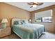 Spacious bedroom with a queen bed and ceiling fan at 8210 Sulky Ct # 5, Port Richey, FL 34668