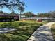 Community area with horseshoe pits and walkway at 8210 Sulky Ct # 5, Port Richey, FL 34668