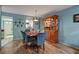 Bright dining room with wood-look floors and built-in hutch at 8210 Sulky Ct # 5, Port Richey, FL 34668