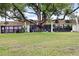 Condo building with a large tree in the front yard at 8210 Sulky Ct # 5, Port Richey, FL 34668