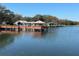 Community lakefront gazebo with wooden dock and scenic views at 8210 Sulky Ct # 5, Port Richey, FL 34668