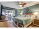 Main bedroom with sliding doors to patio, and a king-size bed at 8210 Sulky Ct # 5, Port Richey, FL 34668
