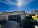 Tan house with garage and landscaped yard at 8524 Corinthian Way, New Port Richey, FL 34654