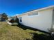 House side view, landscaping, and lawn at 8524 Corinthian Way, New Port Richey, FL 34654