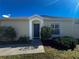 House entrance with blue door and landscaping at 8524 Corinthian Way, New Port Richey, FL 34654