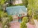 Aerial view of two-story house with teal door and brick driveway at 8711 Betty St, Port Richey, FL 34668