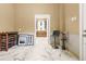 Bright basement area with marble floors and views into a kitchen at 8711 Betty St, Port Richey, FL 34668
