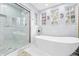 Spa-like bathroom with soaking tub, walk-in shower, and marble tile at 8711 Betty St, Port Richey, FL 34668