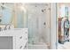 Bathroom with white vanity, marble shower, and jukebox at 8711 Betty St, Port Richey, FL 34668