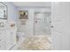 Bathroom with double vanity, walk-in shower, and marble flooring at 8711 Betty St, Port Richey, FL 34668