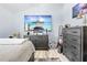 Bright bedroom with large TV, dresser, and light flooring at 8711 Betty St, Port Richey, FL 34668