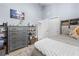 Bedroom with dresser, shelving unit and cozy bedding at 8711 Betty St, Port Richey, FL 34668