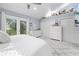 Bright bedroom with a king-size bed, ample closet space and access to a balcony at 8711 Betty St, Port Richey, FL 34668