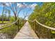 Wooden boardwalk pathway with rope railings, leading to waterfront at 8711 Betty St, Port Richey, FL 34668
