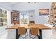 Bright dining room with live edge table and large windows at 8711 Betty St, Port Richey, FL 34668